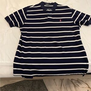 Blue polo with pink logo.